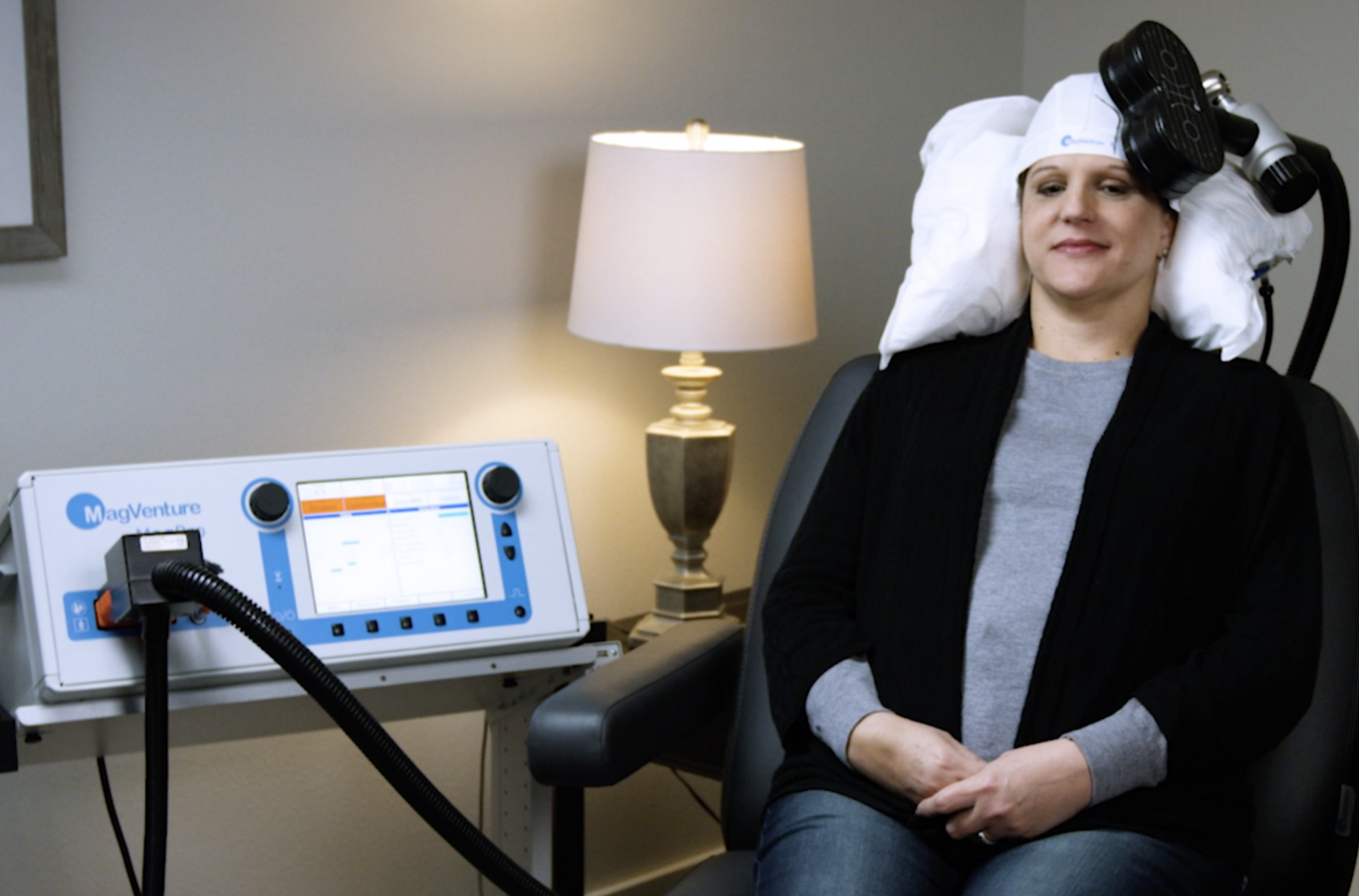 Patient sitting in TMS Therapy Chair Treating